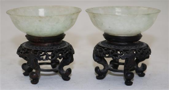 A pair of Chinese ice white and pale green jadeite bowls, early 20th century, diameter 7cm